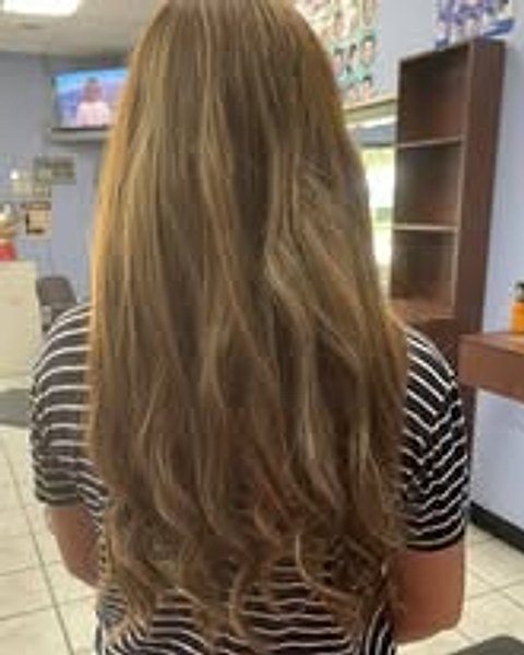 Long brunette hair with sunlit highlights and curled ends